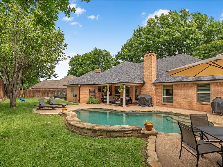 Full roof replacement on Pheasant Ridge in Keller, TX 76248 — RoofDog residential roofing project on a brick home with architectural shingles, backyard pool, and mature landscaping