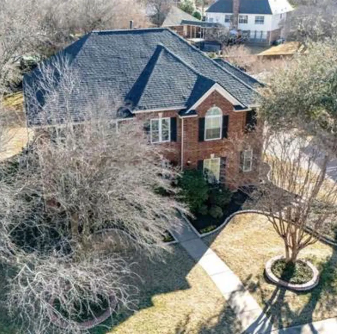 Aerial drone view of a completed Onyx Black Owens Corning Duration Storm roof installation on Mesquite Rd in the Myers Meadow neighborhood of Southlake, TX 76092 — RoofDog residential roofing project