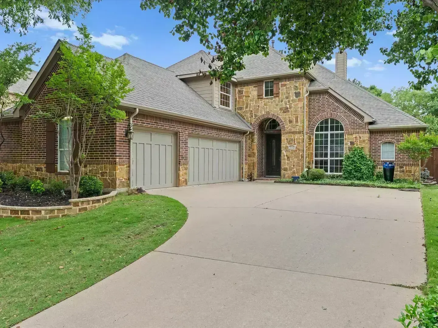 Completed full roof replacement on Victoria Ln in Lantana, TX 76226 — brick and stone estate home with new architectural shingle roof by RoofDog