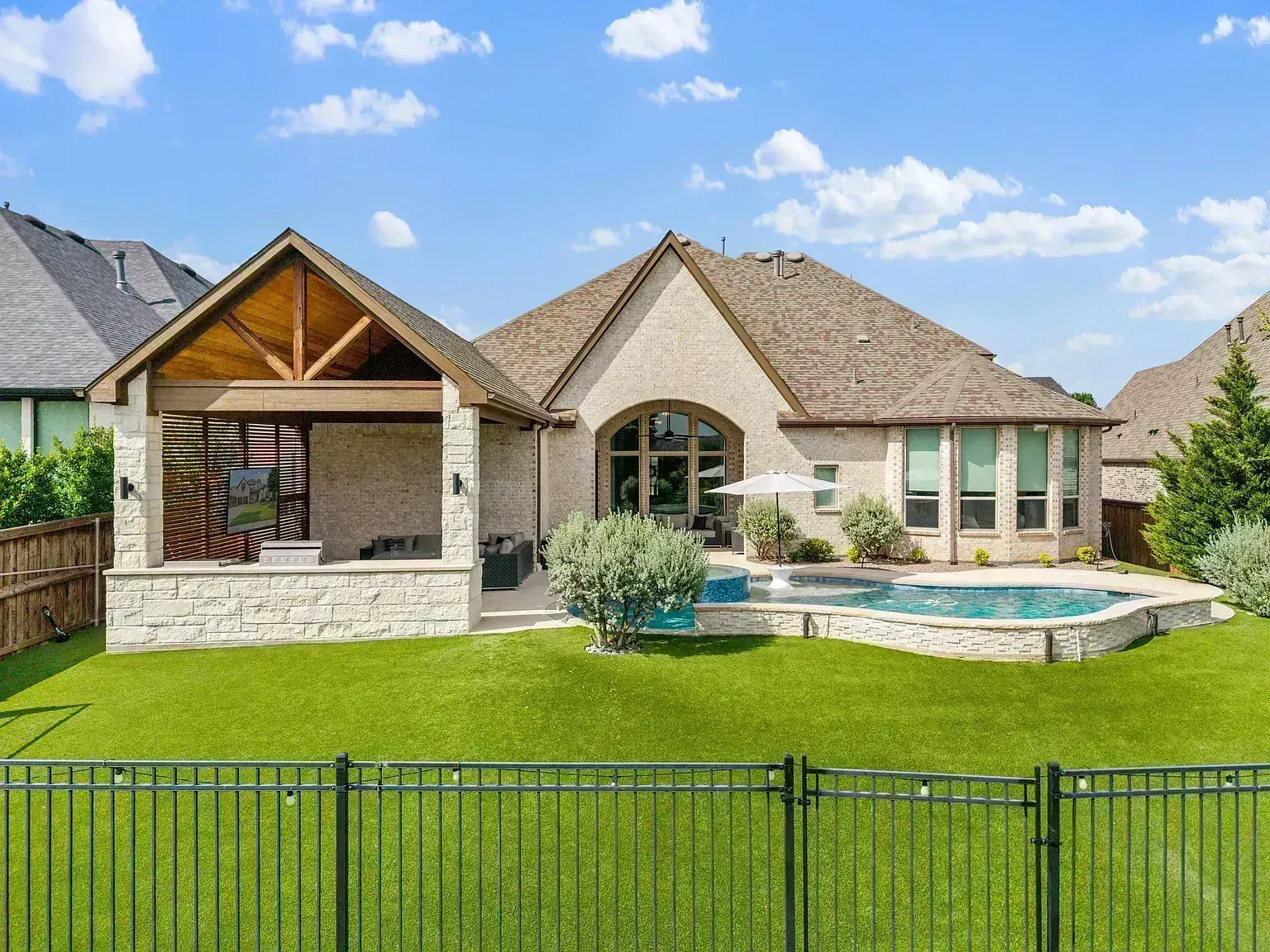 Full roof replacement on Autumn Lake Trail in McKinney, TX 75071 — luxury stone estate with pool and covered outdoor living area, architectural shingles by RoofDog